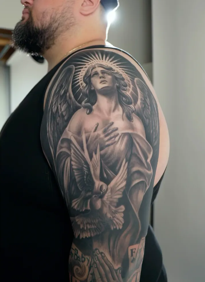Realism angel and dove sleeve tattoo by Andrew Fernandez at Studio AZ Tattoo Minneapolis